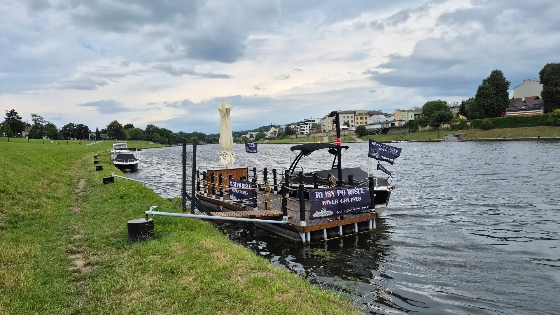 Park Wola Cruises motorboat and floating dock on the Vistula in Kraków